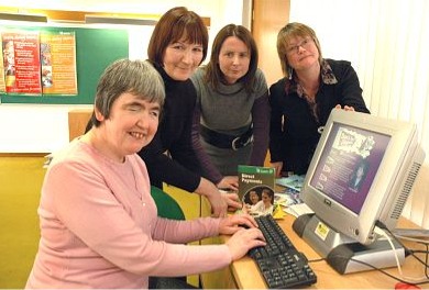 Sue showing her mum, sister and social worker the website
